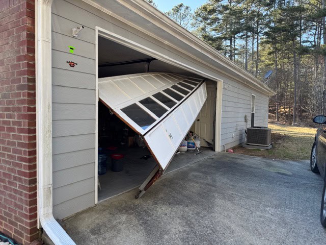 Garage Door that is completely off track.