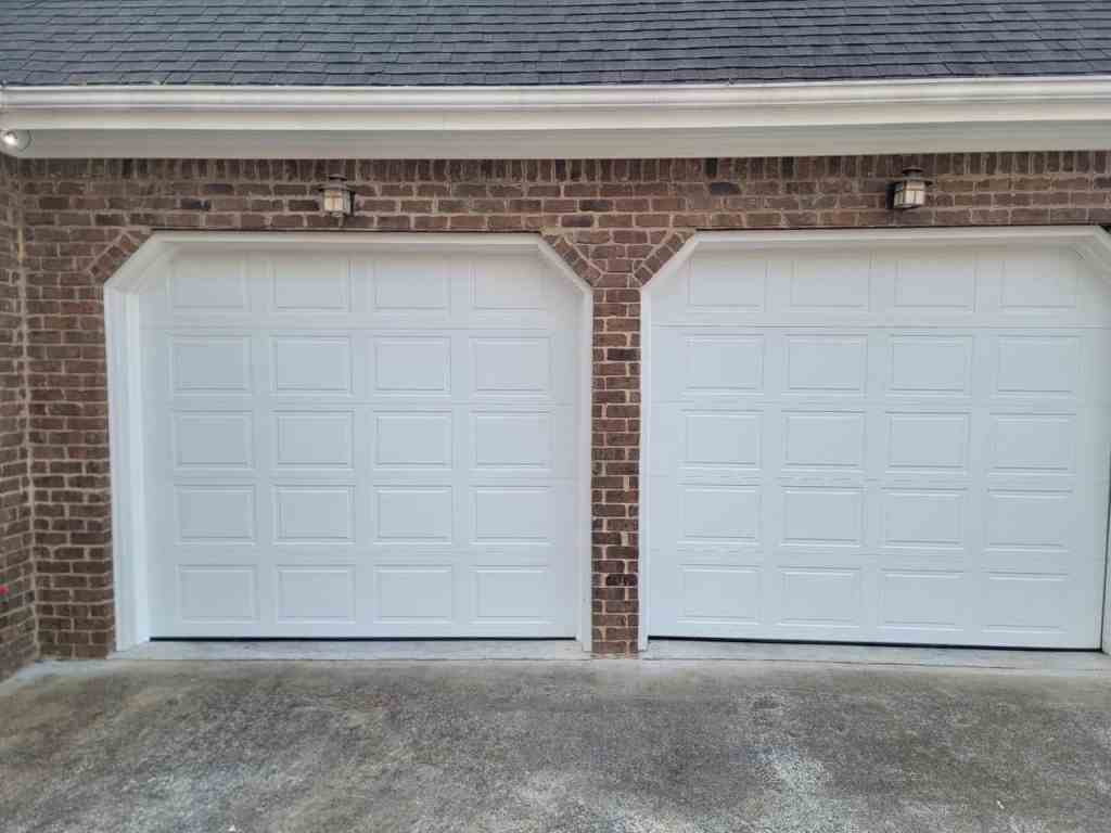White, Short-rasied panel garage doors installed by Georgia Garage Solutions